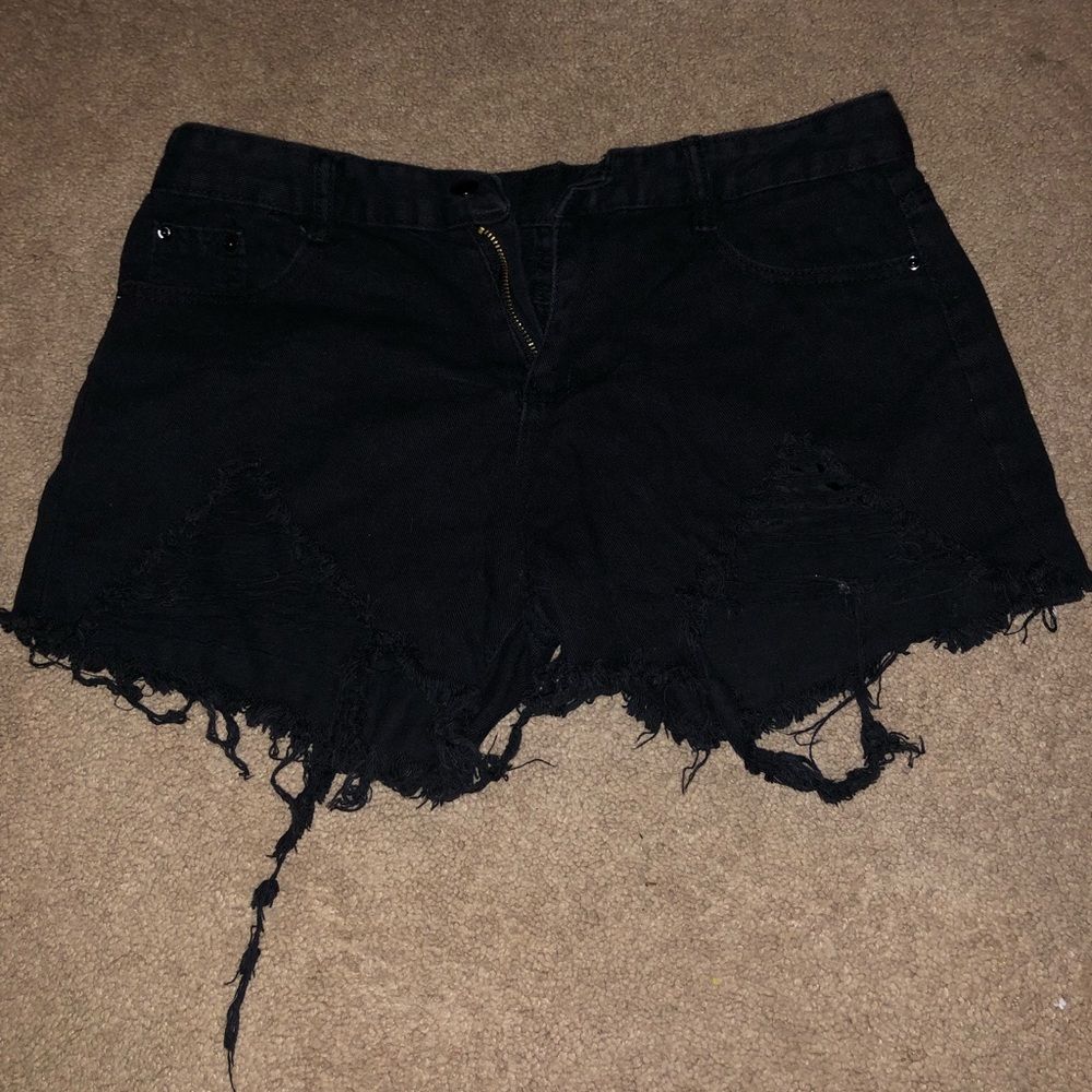 Distressed black shorts.